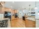 Open kitchen with wood cabinets, granite countertops, gas cooktop and stainless steel appliances at 4319 Sailview Dr, Denver, NC 28037