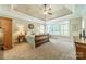 Large main bedroom with carpet floors, tray ceiling, large windows and a seating area at 4319 Sailview Dr, Denver, NC 28037