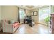 Bright home office featuring hardwood floors, large windows, coffered ceiling, and a modern desk with computer setup at 4319 Sailview Dr, Denver, NC 28037