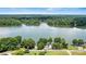 Picturesque aerial view captures the home's lakeside setting surrounded by lush forests and serene waters at 4920 Longfield St, Claremont, NC 28610