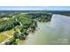 Tranquil aerial scene of a lake property framed by trees, showcasing serene waterfront living at 4920 Longfield St, Claremont, NC 28610