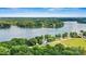 Stunning aerial view of waterfront property nestled on a calm lake surrounded by lush greenery at 4920 Longfield St, Claremont, NC 28610