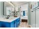 Charming bathroom featuring a bright blue vanity and open access to main bedroom at 4920 Longfield St, Claremont, NC 28610