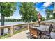 Outdoor deck area overlooking the water with a patio table and seating for six at 4920 Longfield St, Claremont, NC 28610