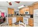 Bright kitchen featuring wooden cabinetry, modern white appliances and a complementary stone backsplash at 4920 Longfield St, Claremont, NC 28610