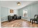 Cozy home office with black desk, stylish chair and a window overlooking the yard at 4920 Longfield St, Claremont, NC 28610