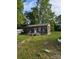 Rustic cabin-style home with weathered wood exterior and a small front porch, surrounded by trees at 5040 Fairview Church Rd, Lincolnton, NC 28092