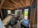 Unfinished interior featuring exposed beams, construction materials, and an open doorway at 5040 Fairview Church Rd, Lincolnton, NC 28092