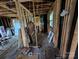 Interior view with exposed framing, electrical wiring, and scattered building supplies at 5040 Fairview Church Rd, Lincolnton, NC 28092