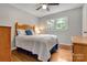 Cozy bedroom features a ceiling fan, natural light, hardwood floors and a comfortable bed at 511 Apple Ln, Bessemer City, NC 28016