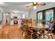 Dining room with a large wooden table, hardwood floors, and adjacent kitchen at 511 Apple Ln, Bessemer City, NC 28016