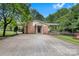 Charming single-story brick home with a covered porch and a spacious driveway at 511 Apple Ln, Bessemer City, NC 28016