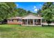 Charming one-story brick home featuring a covered front porch and a well-maintained lawn at 511 Apple Ln, Bessemer City, NC 28016