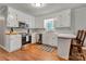 Cozy kitchen with white cabinets, stainless steel appliances, and wood flooring at 511 Apple Ln, Bessemer City, NC 28016