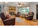 Inviting living room with a brick fireplace, built-in shelves, and hardwood floors at 511 Apple Ln, Bessemer City, NC 28016