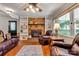 Warm living room with a brick fireplace, built-in shelving and hardwood floors at 511 Apple Ln, Bessemer City, NC 28016