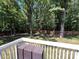 Backyard deck overlooking a private, wooded yard with a wooden fence at 511 Evelyn Ave, Kannapolis, NC 28083