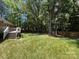 Large, grassy backyard with a deck and a tall wood privacy fence at 511 Evelyn Ave, Kannapolis, NC 28083