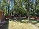 Spacious backyard featuring a wood fence and mature trees offering privacy and a serene outdoor space at 511 Evelyn Ave, Kannapolis, NC 28083