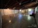Spacious unfinished basement featuring concrete floors and an exposed wood ceiling at 511 Evelyn Ave, Kannapolis, NC 28083