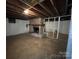 Unfinished basement with brick fireplace, concrete floor, and exposed ceiling at 511 Evelyn Ave, Kannapolis, NC 28083