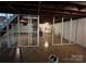 Unfinished basement with brick fireplace, concrete floor, exposed ceiling, and stairs to main floor at 511 Evelyn Ave, Kannapolis, NC 28083