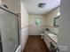 Bathroom featuring a shower, toilet, single vanity, and medicine cabinet at 511 Evelyn Ave, Kannapolis, NC 28083