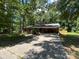 Ranch style home with brick facade, a carport, mature trees and a long driveway at 511 Evelyn Ave, Kannapolis, NC 28083