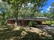 Charming brick home with attached carport nestled among mature trees at 511 Evelyn Ave, Kannapolis, NC 28083