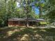 Charming brick home with attached carport nestled among mature trees at 511 Evelyn Ave, Kannapolis, NC 28083