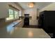 Traditional kitchen with white cabinetry, black appliances, and hardwood flooring at 511 Evelyn Ave, Kannapolis, NC 28083