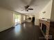 Cozy living room with hardwood floors, a brick fireplace, and access to a deck and kitchen at 511 Evelyn Ave, Kannapolis, NC 28083