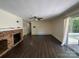 Large living room featuring hardwood floors, a brick fireplace, and sliding door access to an outdoor deck at 511 Evelyn Ave, Kannapolis, NC 28083
