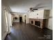 Inviting living room featuring hardwood floors, a brick fireplace, and sliding door access to an outdoor deck at 511 Evelyn Ave, Kannapolis, NC 28083