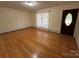 Bright living room featuring hardwood floors, a window, and a welcoming front door at 511 Evelyn Ave, Kannapolis, NC 28083