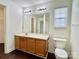 This full bathroom features a wooden vanity and a large mirror at 710 Woodington Ln, Charlotte, NC 28214