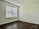 Bedroom with a large window for natural light and hardwood floors at 710 Woodington Ln, Charlotte, NC 28214