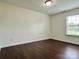 This bedroom features a window for natural light and hardwood floors at 710 Woodington Ln, Charlotte, NC 28214