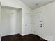 Inviting entryway with wood flooring, a door to the exterior, and a coat closet at 710 Woodington Ln, Charlotte, NC 28214