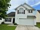 Charming two-story home featuring white siding, red shutters, and an attached two-car garage at 710 Woodington Ln, Charlotte, NC 28214