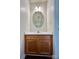 Half bathroom features a wooden vanity with an oval mirror at 710 Woodington Ln, Charlotte, NC 28214