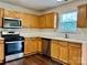 Well-equipped kitchen featuring stainless steel appliances and wooden cabinets at 710 Woodington Ln, Charlotte, NC 28214