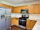Well-equipped kitchen featuring stainless steel appliances and wooden cabinets at 710 Woodington Ln, Charlotte, NC 28214