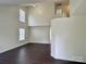 Bright living room with soaring ceilings, large windows, and hardwood floors at 710 Woodington Ln, Charlotte, NC 28214