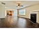 Open-concept room with hardwood floors, a fireplace, and access to the kitchen at 710 Woodington Ln, Charlotte, NC 28214