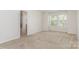 Bright bedroom with neutral carpet, two windows, and ensuite bathroom access at 724 Little Bluestem Dr, Lake Wylie, SC 29710