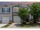 Beautiful townhome with stone details, a two-car garage, and well-maintained landscaping at 724 Little Bluestem Dr, Lake Wylie, SC 29710