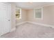 Bright bedroom with fresh carpet, neutral decor, and natural light at 730 Marble St, Charlotte, NC 28208