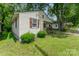 A side view of a single-story home with simple landscaping and classic siding at 730 Marble St, Charlotte, NC 28208