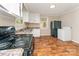 Functional kitchen featuring white cabinets, laminate countertops, and black appliances at 730 Marble St, Charlotte, NC 28208